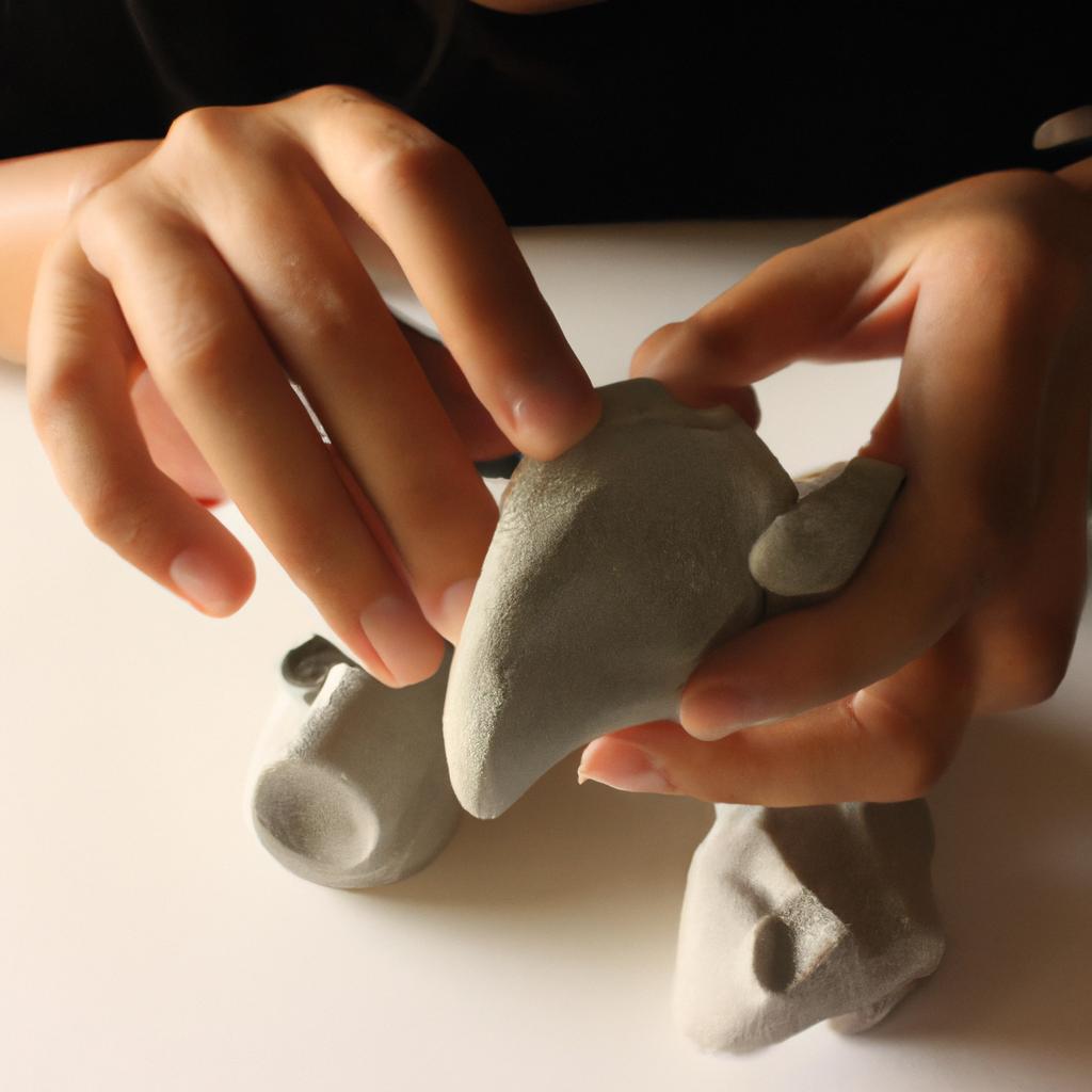 Person sculpting with clay